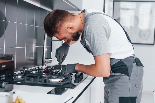 young-professional-plumber-in-grey-uniform-working-resize.jpg